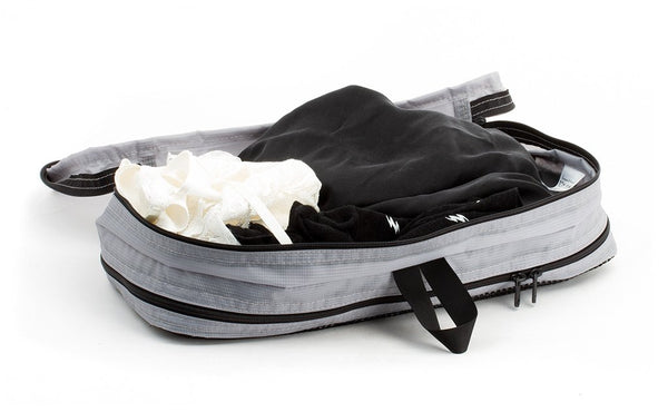 A few pairs of undergarments in an open Northwest Sky (light grey) Aether Small Aeronaut 45 Packing Cube all-fabric side up.